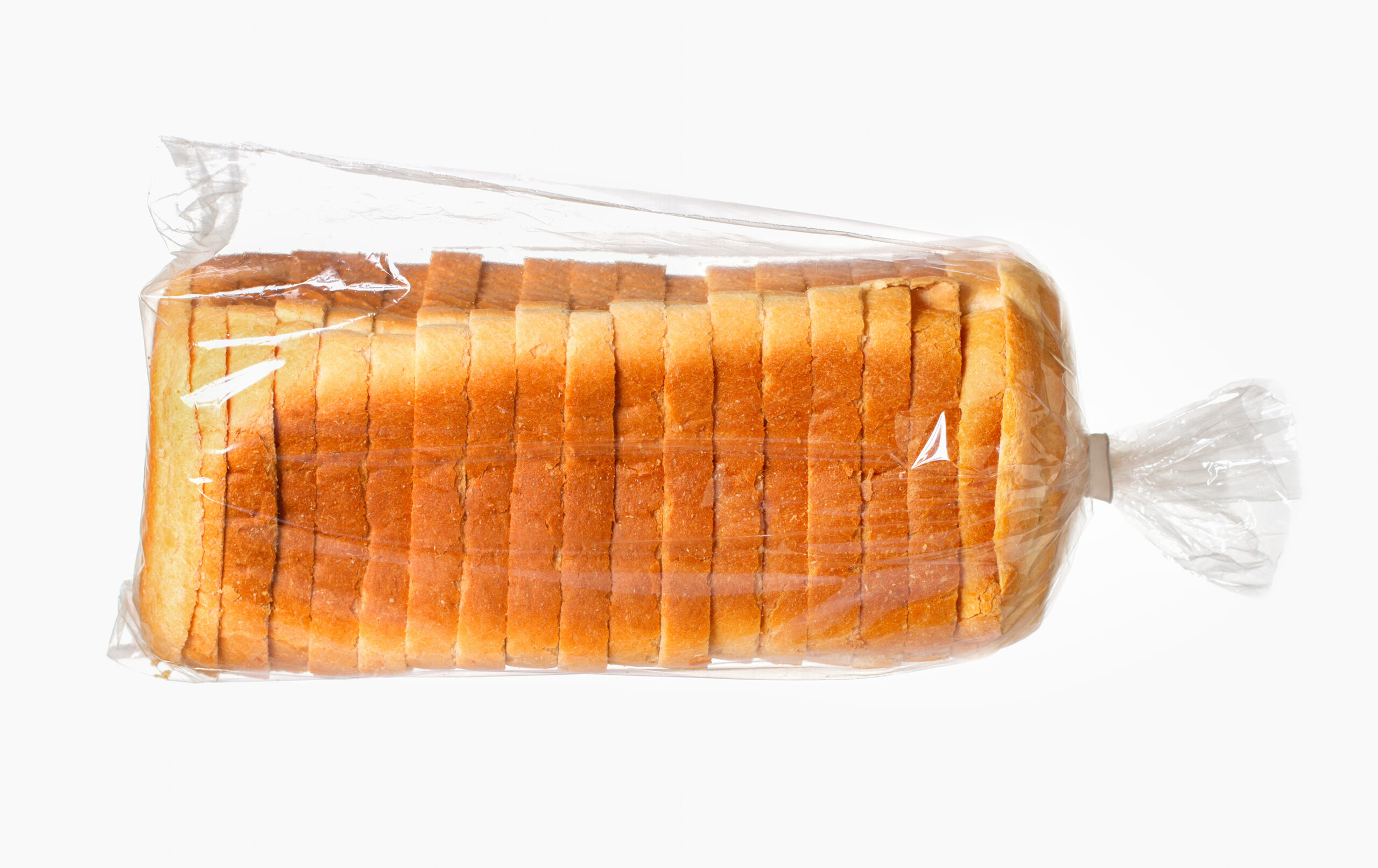 Sliced bread on white surface.